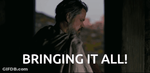 A Man With A Beard Is Standing In Front Of A Window And Says Bringing It All . GIF
