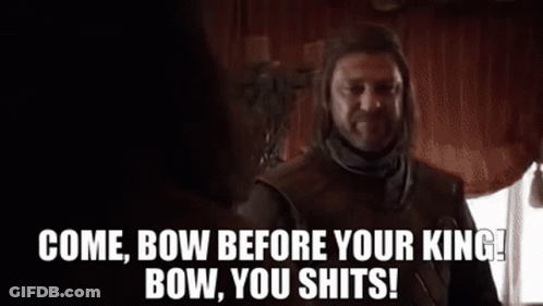 A Man With A Beard Is Standing In Front Of A Window And Talking To Another Man In A Room . GIF