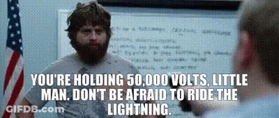 A Man With A Beard Is Standing In Front Of An American Flag And A White Board With A Quote On It GIF