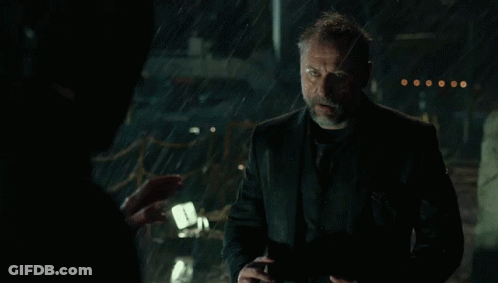 A Man With A Beard Is Standing In The Rain With His Mouth Open . GIF
