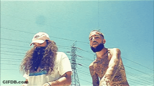 A Man With A Beard Is Standing Next To A Man With Long Hair GIF
