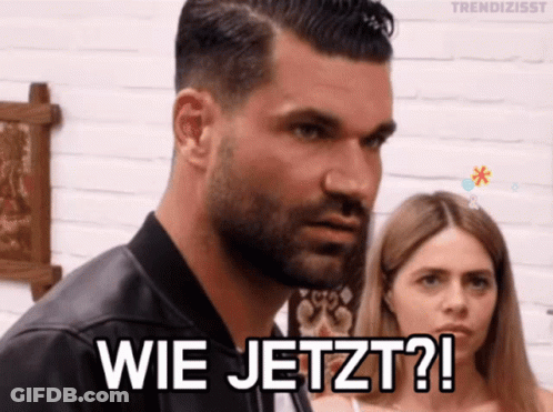 A Man With A Beard Is Standing Next To A Woman And Says " Wie Jetzt " GIF