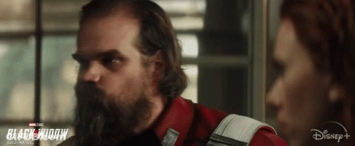 Man With Beard Next To Woman In Black Widow Ad GIF