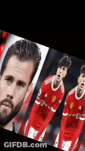 A Man With A Beard Is Standing Next To Two Soccer Players In Red Uniforms . GIF