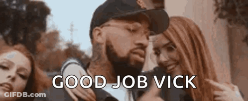 A Man With A Beard Is Standing Next To Two Women And Giving A Thumbs Up Sign . GIF