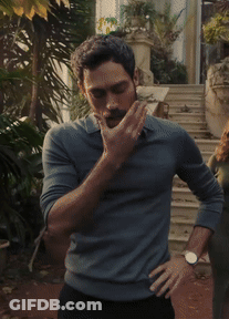 A Man With A Beard Is Standing With His Hands On His Hips And A Watch On His Wrist GIF