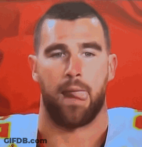 A Man With A Beard Is Sticking His Tongue Out In A Close Up Of His Face . GIF