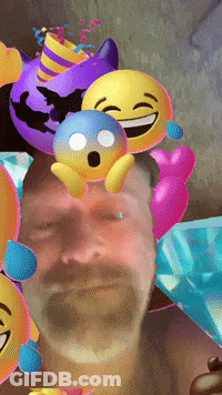 A Man With A Beard Is Surrounded By Balloons And Emojis GIF