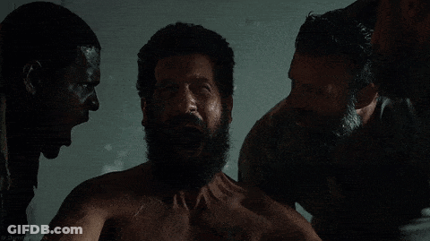 A Man With A Beard Is Surrounded By Two Other Men With Their Mouths Open GIF