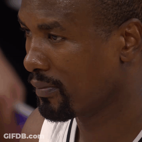 A Man With A Beard Is Sweating And Looking Down GIF