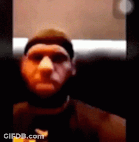 A Man With A Beard Is Taking A Selfie With A Camera . GIF