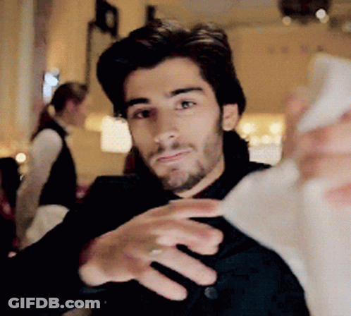 A Man With A Beard Is Taking A Selfie With His Phone GIF