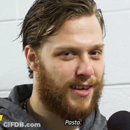 A Man With A Beard Is Talking Into A Microphone And The Word Pasta Is On His Face GIF
