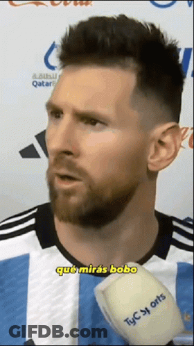 A Man With A Beard Is Talking Into A Microphone Which Says Tyc Sports On It GIF