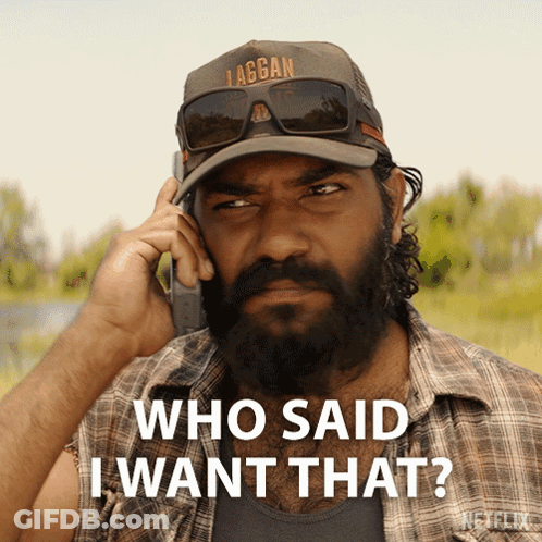 A Man With A Beard Is Talking On A Cell Phone With The Words Who Said I Want That Below Him GIF