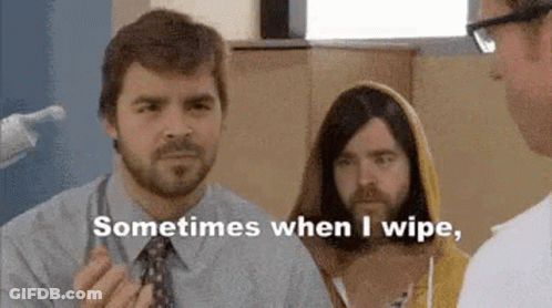 A Man With A Beard Is Talking To A Doctor While Another Man In A Yellow Hoodie Looks On . GIF