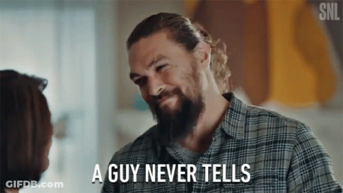 A Man With A Beard Is Talking To A Woman And Says " A Guy Never Tells " GIF