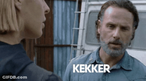 A Man With A Beard Is Talking To A Woman And The Word Kekker Is On The Screen Behind Him GIF