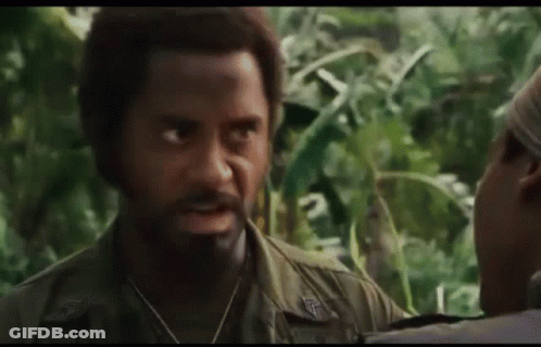 A Man With A Beard Is Talking To A Woman In The Jungle . GIF