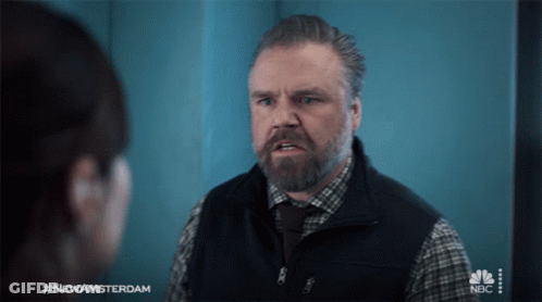 A Man With A Beard Is Talking To A Woman With #Newamsterdam On The Bottom GIF
