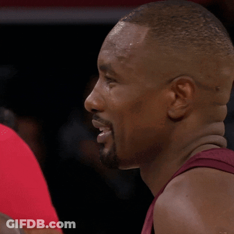 A Man With A Beard Is Talking To Another Man In A Red Shirt GIF