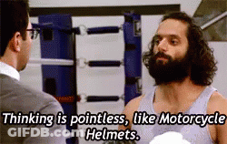 A Man With A Beard Is Talking To Another Man While Wearing Boxing Gloves . GIF