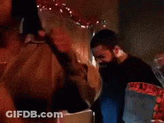 A Man With A Beard Is Touching Another Man 'S Face GIF