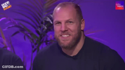 A Man With A Beard Is Waving His Hand And Saying Hi Mum . GIF