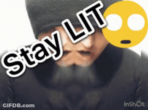 A Man With A Beard Is Wearing A Black Hat And Has The Words Stay Lit On His Face GIF