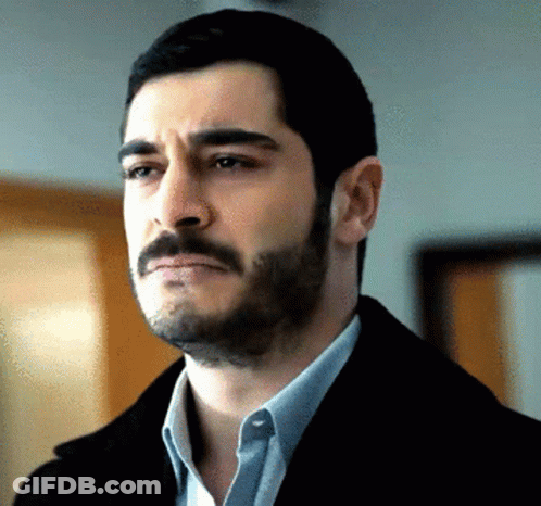 A Man With A Beard Is Wearing A Black Jacket GIF