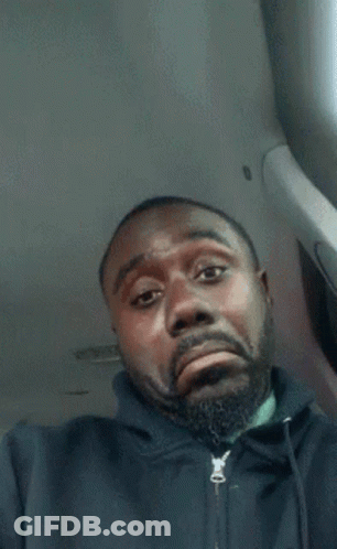 A Man With A Beard Is Wearing A Black Jacket With A Zipper On The Front GIF