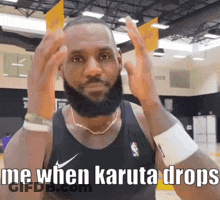 A Man With A Beard Is Wearing A Black Nike Tank Top And A Necklace . GIF