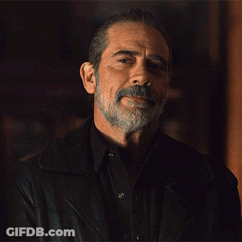 A Man With A Beard Is Wearing A Black Shirt And A Leather Jacket GIF