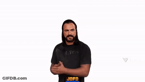 A Man With A Beard Is Wearing A Black Shirt And Giving A Thumbs Up Sign . GIF