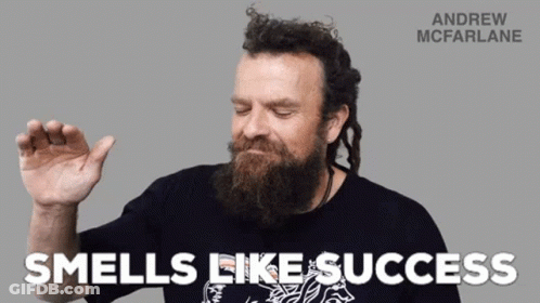 A Man With A Beard Is Wearing A Black Shirt That Says Andrew Mcfarlane GIF