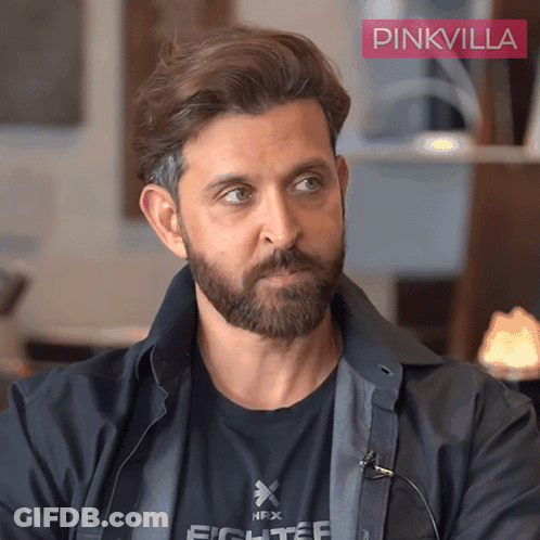A Man With A Beard Is Wearing A Black Shirt That Says Fighter On It GIF