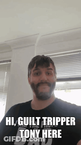 A Man With A Beard Is Wearing A Black Shirt That Says Guilt Tripper Tony Here GIF