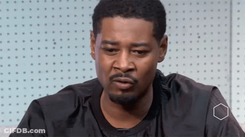 A Man With A Beard Is Wearing A Black Shirt That Says Nike GIF