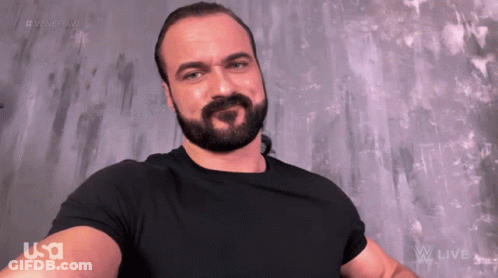 A Man With A Beard Is Wearing A Black Shirt That Says Usa On The Arm GIF