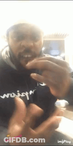 A Man With A Beard Is Wearing A Black Shirt That Says ' Woisq ' On It GIF
