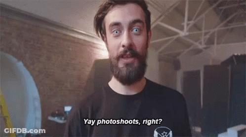 A Man With A Beard Is Wearing A Black Shirt That Says " Yay Photoshoots Right " . GIF
