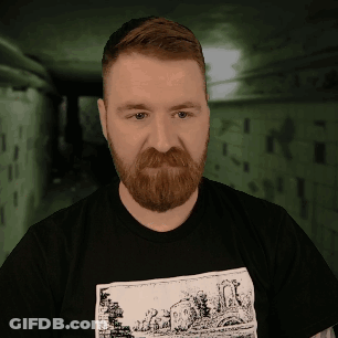 A Man With A Beard Is Wearing A Black Shirt With A Drawing Of A House On It GIF