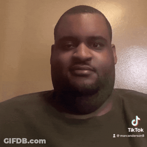 A Man With A Beard Is Wearing A Black Shirt With A Tiktok Logo On It GIF