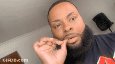 A Man With A Beard Is Wearing A Black Shirt With The Letter A On It GIF