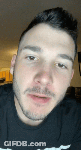 A Man With A Beard Is Wearing A Black Shirt With The Word Champion On It GIF