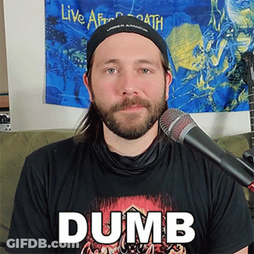 A Man With A Beard Is Wearing A Black Shirt With The Word Dumb On It GIF
