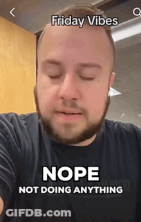 A Man With A Beard Is Wearing A Black Shirt With The Words Friday Vibes Nope Not Doing Anything On It . GIF
