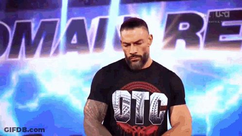 A Man With A Beard Is Wearing A Black T-Shirt That Says Gtc . GIF