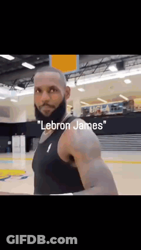 A Man With A Beard Is Wearing A Black Tank Top With The Word Lebron James On It . GIF