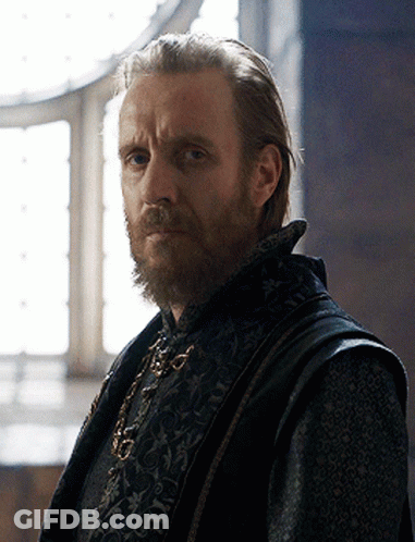 A Man With A Beard Is Wearing A Black Vest With A Floral Pattern GIF